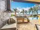 Stainless steel appliances and stone finishes in this outdoor kitchen at 12812 Jacob Grace Ct, Windermere, FL 34786