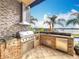 Luxury outdoor kitchen with grill, sink, and refrigerator at 12812 Jacob Grace Ct, Windermere, FL 34786