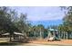 Community playground with play structures, swings, and basketball court at 12812 Jacob Grace Ct, Windermere, FL 34786