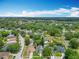 Overhead shot of a residential area with well-spaced houses, green lawns, and a mix of natural woodlands at 13111 Point O Wood Ct, Orlando, FL 32828