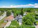 An aerial shot features tidy houses with manicured lawns, interspersed with mature trees in a quiet neighborhood at 13111 Point O Wood Ct, Orlando, FL 32828