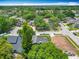 An aerial view showcases a neighborhood with mature trees and well-maintained homes in a suburban setting at 13111 Point O Wood Ct, Orlando, FL 32828