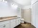 Well-lit bathroom featuring double sinks, granite countertops, and a tiled shower at 13111 Point O Wood Ct, Orlando, FL 32828