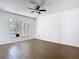 Bright bedroom with wood-look flooring and a window that provides natural lighting at 13111 Point O Wood Ct, Orlando, FL 32828