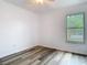 Bright bedroom with a ceiling fan, wood floors, and a window with green views at 13111 Point O Wood Ct, Orlando, FL 32828