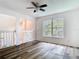 Bedroom featuring modern flooring, ceiling fan, and a large window for plenty of sunlight at 13111 Point O Wood Ct, Orlando, FL 32828