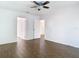 Bright bedroom featuring dark wood-look floors and access to the rest of the home at 13111 Point O Wood Ct, Orlando, FL 32828