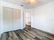 Bedroom featuring gray wood flooring, closet, ceiling fan and an entry at 13111 Point O Wood Ct, Orlando, FL 32828