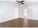 Bright bedroom featuring dark wood-look floors, ceiling fan, and access to the bathroom at 13111 Point O Wood Ct, Orlando, FL 32828