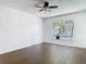 Bright bedroom featuring wood-look floors, a ceiling fan, and large windows for natural light at 13111 Point O Wood Ct, Orlando, FL 32828