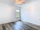 Bright bedroom with a ceiling fan, wood floors, and a window with natural light at 13111 Point O Wood Ct, Orlando, FL 32828