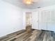 Bedroom featuring gray wood flooring, a closet, ceiling fan and entry to other spaces at 13111 Point O Wood Ct, Orlando, FL 32828