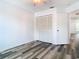 Bedroom featuring gray wood flooring and a closet with shuttered doors at 13111 Point O Wood Ct, Orlando, FL 32828