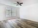 Bedroom featuring modern flooring, ceiling fan, and a large window for plenty of sunlight at 13111 Point O Wood Ct, Orlando, FL 32828