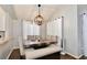 Dining area with wood table, bench seating, and a chandelier at 13111 Point O Wood Ct, Orlando, FL 32828