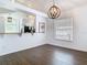 Open-concept dining room with views into the kitchen, wood floors, and modern lighting at 13111 Point O Wood Ct, Orlando, FL 32828