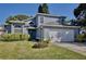 Two-story house with gray siding, white garage door, and manicured lawn at 13111 Point O Wood Ct, Orlando, FL 32828