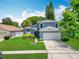 Charming home with a well-maintained lawn and a spacious two-car garage at 13111 Point O Wood Ct, Orlando, FL 32828