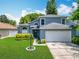 Lovely home with green lawn, neatly trimmed bushes, and a two-car garage at 13111 Point O Wood Ct, Orlando, FL 32828
