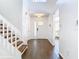 Bright foyer with wood flooring and a staircase with white railing at 13111 Point O Wood Ct, Orlando, FL 32828