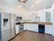 Well-lit kitchen boasts granite counters, stainless steel appliances, and white cabinets at 13111 Point O Wood Ct, Orlando, FL 32828