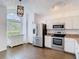 Bright kitchen featuring white cabinets, stainless steel appliances, and granite countertops at 13111 Point O Wood Ct, Orlando, FL 32828