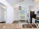 Bright eat-in kitchen featuring stainless steel appliances, granite countertops, and a large arched window at 13111 Point O Wood Ct, Orlando, FL 32828