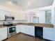 Kitchen with white cabinets, granite countertops and stainless steel appliances at 13111 Point O Wood Ct, Orlando, FL 32828
