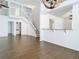 Open floor plan featuring wood-look flooring and a staircase to the second level at 13111 Point O Wood Ct, Orlando, FL 32828