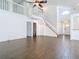 Bright open-concept living room featuring a staircase to the second floor at 13111 Point O Wood Ct, Orlando, FL 32828