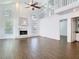 Spacious living room featuring wood-look flooring, high ceilings, and a fireplace at 13111 Point O Wood Ct, Orlando, FL 32828