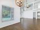Bright living room boasts wood-look flooring and a view of the screened pool at 13111 Point O Wood Ct, Orlando, FL 32828