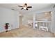 Spacious loft area with wood railing overlooking the main floor at 13111 Point O Wood Ct, Orlando, FL 32828