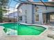 Backyard boasts refreshing pool with screened enclosure at 13111 Point O Wood Ct, Orlando, FL 32828