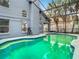 Relaxing pool with screened enclosure and lush tropical landscaping at 13111 Point O Wood Ct, Orlando, FL 32828