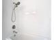 Bathtub with white subway tile surround and modern shower head fixtures at 13111 Point O Wood Ct, Orlando, FL 32828
