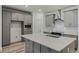 Modern kitchen with gray cabinets and quartz countertops at 13552 Autumn Harvest Ave, Winter Garden, FL 34787