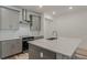 Modern kitchen with gray cabinets, quartz countertops and a stainless steel range hood at 13552 Autumn Harvest Ave, Winter Garden, FL 34787