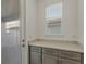 Laundry room with gray cabinets, granite countertops, and an exterior door at 13552 Autumn Harvest Ave, Winter Garden, FL 34787