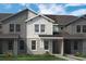 Modern two-story townhome with gray and white exterior at 13556 Autumn Harvest Ave, Winter Garden, FL 34787