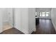 Hallway with wood-look floors leading to bathroom and living areas at 13556 Autumn Harvest Ave, Winter Garden, FL 34787