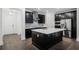 Modern kitchen with dark cabinetry, quartz countertops, and island at 13556 Autumn Harvest Ave, Winter Garden, FL 34787