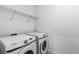 Bright laundry room with Samsung washer and dryer, and ample shelving at 13556 Autumn Harvest Ave, Winter Garden, FL 34787