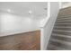 Modern staircase leading to upper level with hardwood floors below at 13556 Autumn Harvest Ave, Winter Garden, FL 34787