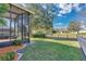 Landscaped backyard with screened porch at 140 Gladesdown Ct, Deland, FL 32724