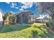 Screened patio, lush lawn, and mature trees create a relaxing outdoor space at 140 Gladesdown Ct, Deland, FL 32724