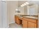 Double vanity bathroom with wood cabinets and tile flooring at 140 Gladesdown Ct, Deland, FL 32724