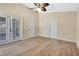 Spacious bedroom with double doors leading to the outdoors and light wood flooring at 140 Gladesdown Ct, Deland, FL 32724