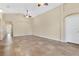 Spacious living area with tile floors and access to hallway at 140 Gladesdown Ct, Deland, FL 32724