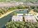 Aerial view of homes near a pond with lush greenery at 1407 Retreat Cir, Clermont, FL 34714